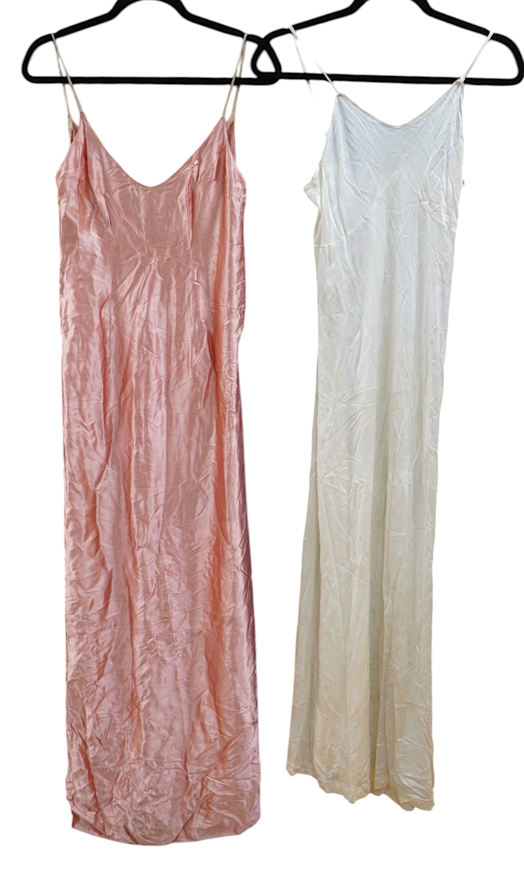 Two late 19th early 20th century long baby night gowns and two shorter baby gowns, together with a pink satin ladies full length slip and a similar cream silk stockinette slip, the bodices worked on baby dresses are embr